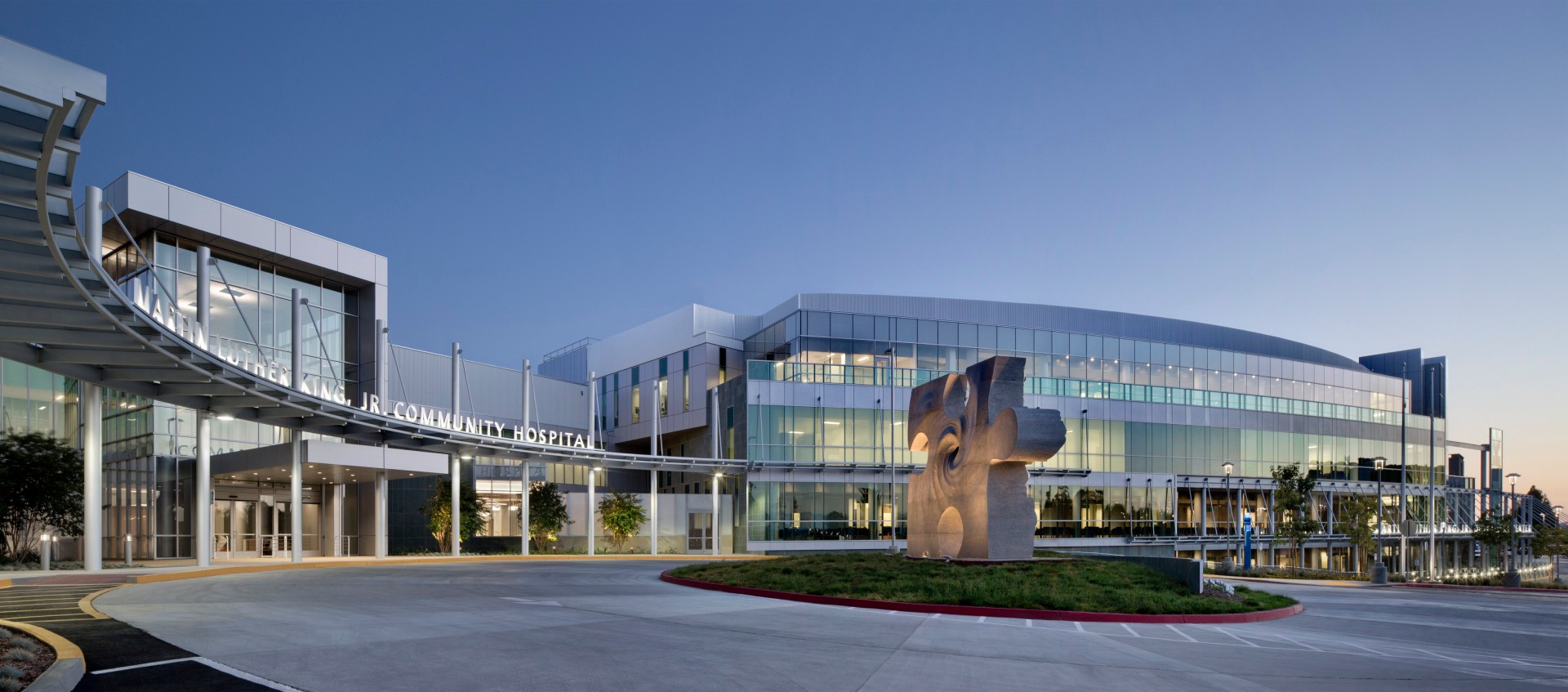 A puzzle piece sculpture sits in the center of the entry port, a symbol of how important the facility is to the fabric of its neighborhood and lips set in behind it represent the voices of those that kept it alive.