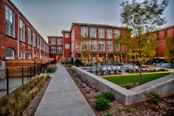 A series of courtyards at the center of the residential portion of Judson Mill creates relaxing exterior living spaces and provides natural light to the interior residential units. A series of courtyards at the center of the residential portion of Judson Mill creates relaxing exterior living spaces and provides natural light to the interior residential units.