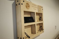 This wooden charging station features a QR code that people can scan to see a customized landing page that tracks metrics about the energy generated by the windows. This wooden charging station features a QR code that people can scan to see a customized landing page that tracks metrics about the energy generated by the windows.