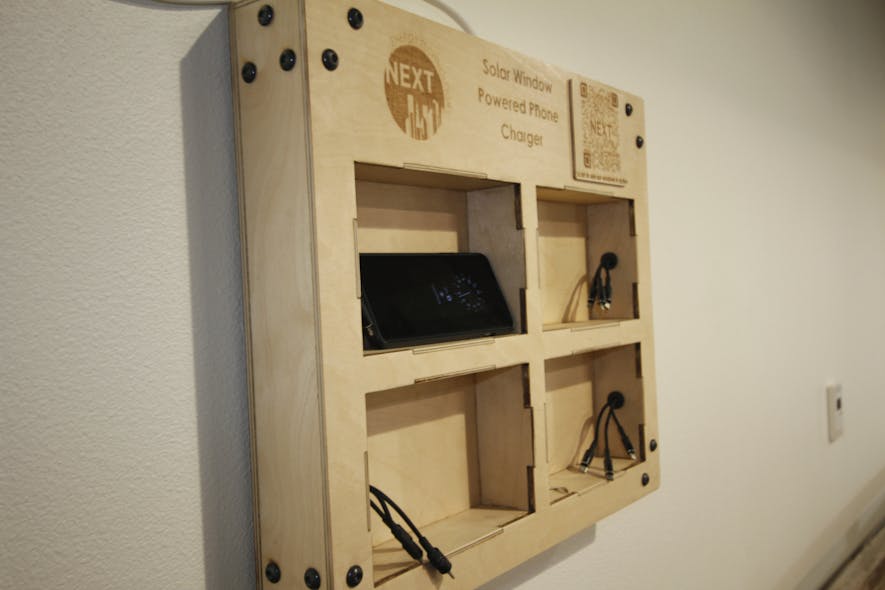 This wooden charging station features a QR code that people can scan to see a customized landing page that tracks metrics about the energy generated by the windows.