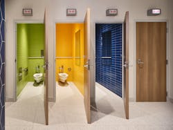 These spacious and colorful bathrooms for Austin PBS include playful &ldquo;On Air&rdquo; lights to indicate occupancy.