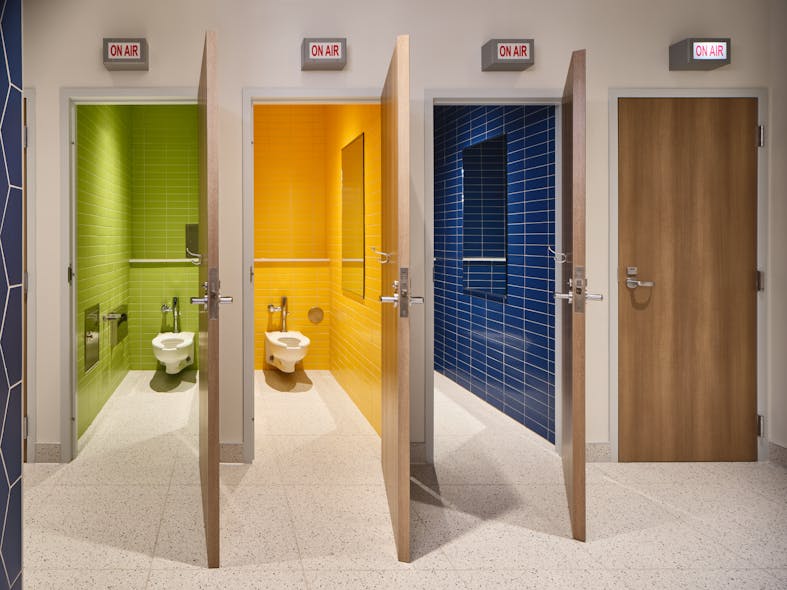 These spacious and colorful bathrooms for Austin PBS include playful &ldquo;On Air&rdquo; lights to indicate occupancy.