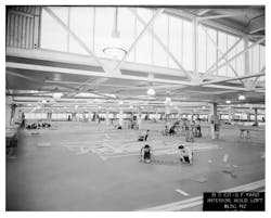 Building 12 once housed the foremost shipbuilding facility in the U.S. during WWII. Workers seen here are scaling up vessel plans in 1941. Building 12 once housed the foremost shipbuilding facility in the U.S. during WWII. Workers seen here are scaling up vessel plans in 1941.