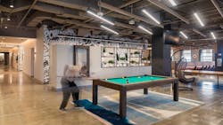 The full-floor cafeteria amenity designed by Dyer Brown for financial services firm Manulife in Boston offers multiple serveries, a coffee kiosk staffed with a barista, and a selection of free-to-play games — a strategy that has encouraged employees to return to in-person work. The full-floor cafeteria amenity designed by Dyer Brown for financial services firm Manulife in Boston offers multiple serveries, a coffee kiosk staffed with a barista, and a selection of free-to-play games — a strategy that has encouraged employees to return to in-person work.