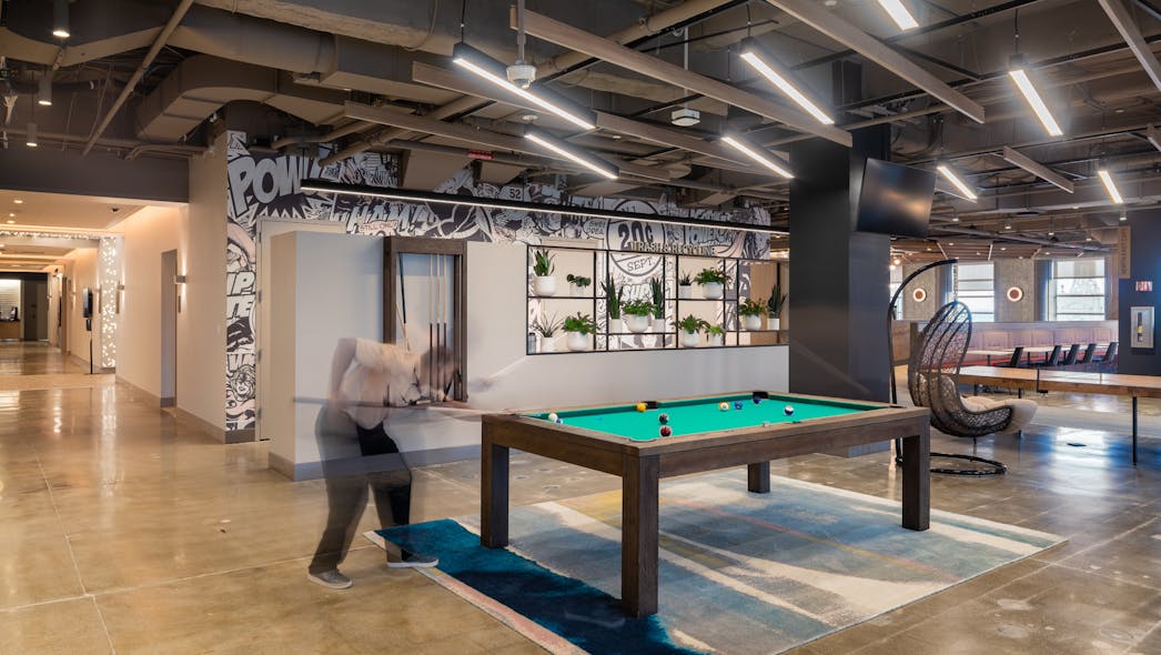 The full-floor cafeteria amenity designed by Dyer Brown for financial services firm Manulife in Boston offers multiple serveries, a coffee kiosk staffed with a barista, and a selection of free-to-play games &mdash; a strategy that has encouraged employees to return to in-person work.