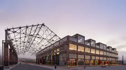 The 230,000-square-foot facility welcomes visitors to the grand market hall via three colossal, red portals and fully operable window walls along key facades to provide maximum porosity between the interior market hall and the surrounding pedestrian plazas and streets.
