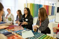 Visitors to this NeoCon showroom examine textiles. The 2023 show embodied its theme, &ldquo;Together We Design.&rdquo;