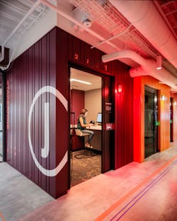Phone rooms are designed to resemble shipping containers. Each room is wired with a tunable white lighting system along with an occupancy device to switch the exterior wall light from white to red. Phone rooms are designed to resemble shipping containers. Each room is wired with a tunable white lighting system along with an occupancy device to switch the exterior wall light from white to red.
