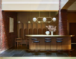 To preserve the building's historic character, the design team stripped back materials, exposing the building's original brick and terrazzo flooring. To preserve the building's historic character, the design team stripped back materials, exposing the building's original brick and terrazzo flooring.