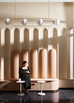 Drawing inspiration from the building’s facade, fluted scallops in the lobby catch light in dramatic ways that changes with the course of the day. Drawing inspiration from the building’s facade, fluted scallops in the lobby catch light in dramatic ways that changes with the course of the day.