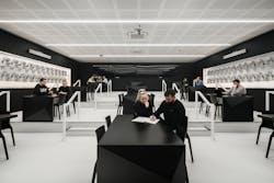The XR Lab’s Lecture Theatre has 60 VR headsets and a video wall with 32 screens. Note how the work tables mimic the color and shape of the lab’s exterior feature wall. The XR Lab’s Lecture Theatre has 60 VR headsets and a video wall with 32 screens. Note how the work tables mimic the color and shape of the lab’s exterior feature wall.
