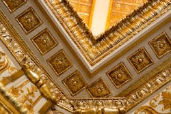 Decisions to refurbish craftsmanship, such as gilded plaster molding with gold-leaf detailing in the double-height lobby ceiling, was important to the owner’s vision for respecting the building’s historic significance. Decisions to refurbish craftsmanship, such as gilded plaster molding with gold-leaf detailing in the double-height lobby ceiling, was important to the owner’s vision for respecting the building’s historic significance.