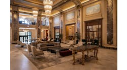 The Belden-Stratford&rsquo;s ornate double-height lobby features restored original elements such as gilded plaster molding and gold-leaf detailing.