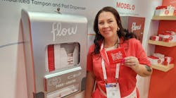 Jen Lyttle, vice president of sales for Aunt Flow, demonstrates the company&rsquo;s free-vend dispensers.