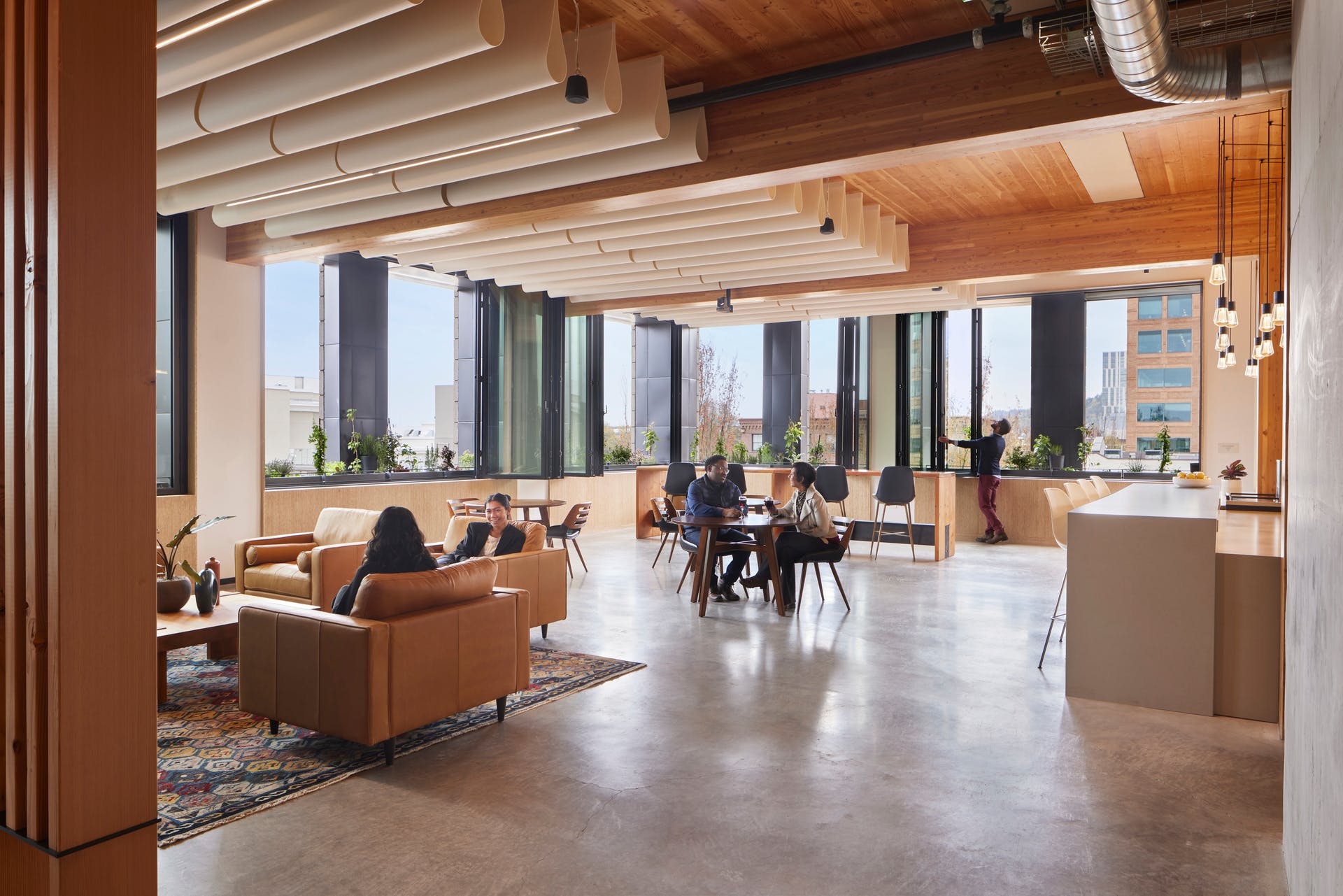 On the PAE Living Building's fifth floor, occupants enjoy a 'deckony' with gathering spaces, fresh air, expansive views out, and elements of biophilic design.