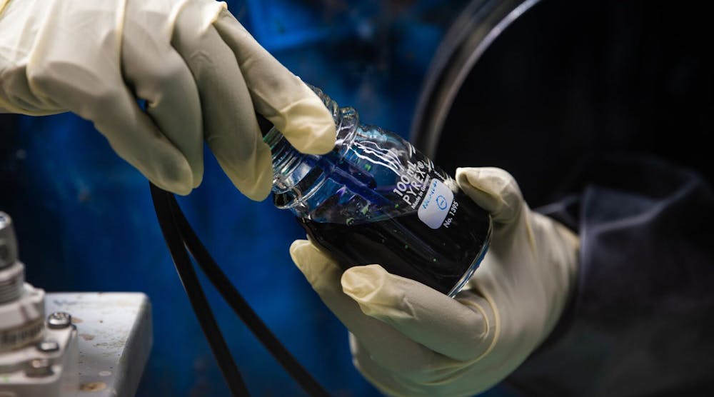 Researchers prepare an experimental flow battery electrolyte that has shown long life in the laboratory setting.
