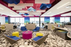 Custom carpet transitions from deep gray to white sit alongside colorful ergonomic chairs reused from Method&rsquo;s former office.