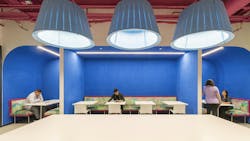 Break room booths are colored in blue walls, accented with drum-shaped light pendants, where employees can eat, relax and socialize.