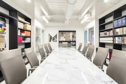 The conference room contrasts the rest of the office with its neutral design, enabling designers to present clients with different design ideas.