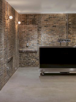 Brewery tap room with exposed brick and concrete floors. Brewery tap room with exposed brick and concrete floors.