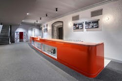 Long, orange bar area with historic architectural details around door framing. Long, orange bar area with historic architectural details around door framing.