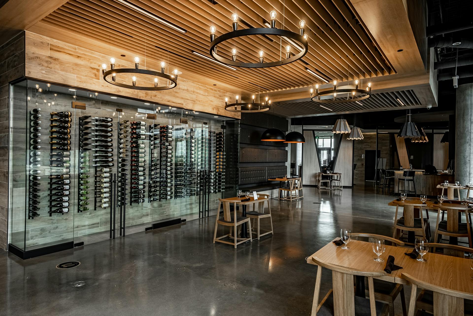 Eureka Lighting Mute fixtures fill volumetric space in a high-ceiling bar area and also deliver a pleasant aural environment. (Photo credit: All images courtesy of Eureka, an Acuity brand.)