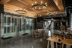 Eureka Lighting Mute fixtures fill volumetric space in a high-ceiling bar area and also deliver a pleasant aural environment. (Photo credit: All images courtesy of Eureka, an Acuity brand.) Eureka Lighting Mute fixtures fill volumetric space in a high-ceiling bar area and also deliver a pleasant aural environment. (Photo credit: All images courtesy of Eureka, an Acuity brand.)