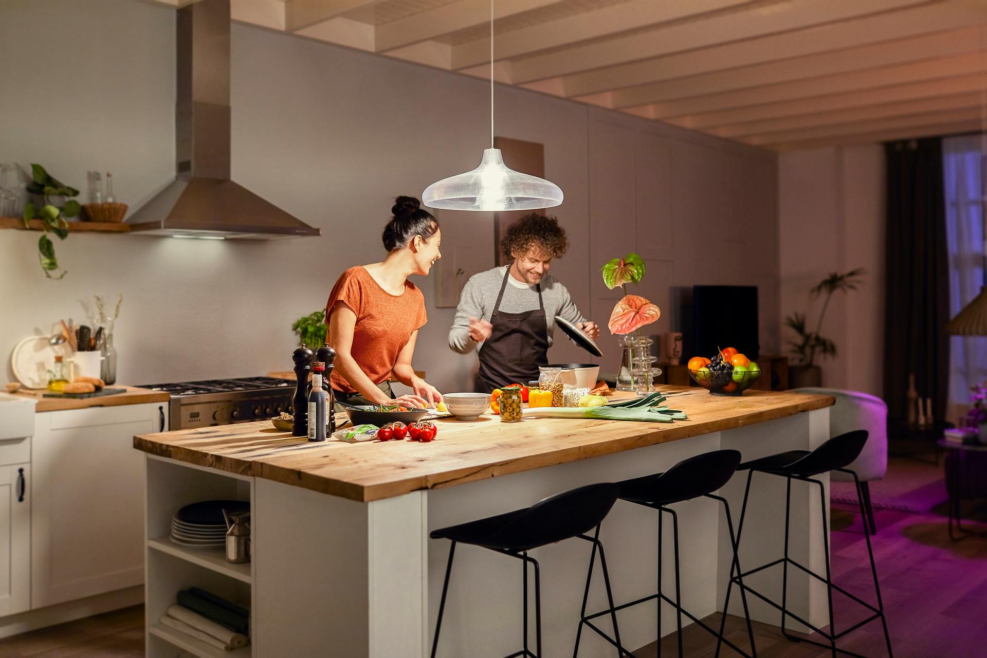 This modern couple will have an easier time eyeballing whether it&rsquo;s quinoa or couscous in the bowl now that they have 1600 Hue lumens shining down. (Photo credit: Image courtesy of Signify.)