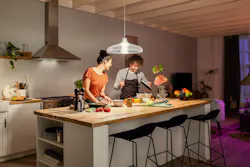 This modern couple will have an easier time eyeballing whether it’s quinoa or couscous in the bowl now that they have 1600 Hue lumens shining down. (Photo credit: Image courtesy of Signify.) This modern couple will have an easier time eyeballing whether it’s quinoa or couscous in the bowl now that they have 1600 Hue lumens shining down. (Photo credit: Image courtesy of Signify.)