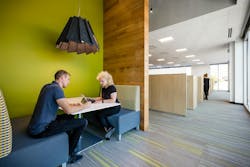 Employees at the Netscout Texas headquarters are working under human-centric lighting in what supplier Eureka Lighting calls an “employee-centric design,” which combines glare-minimizing features for eye comfort with acoustic muting capability to enable collaboration in a communal workspace. (Photo credit: Image courtesy of Eureka Lighting.) Employees at the Netscout Texas headquarters are working under human-centric lighting in what supplier Eureka Lighting calls an “employee-centric design,” which combines glare-minimizing features for eye comfort with acoustic muting capability to enable collaboration in a communal workspace. (Photo credit: Image courtesy of Eureka Lighting.)