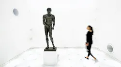 FIG. 1. Planar lighting behind a textile surface delivers an almost dimensionless space where visitors see the Greek athlete Apoxyomenos risen from the seabed, presented with no shadows yet with lighting that reveals the architectural detail of the bronze work. (Photo credit: All photos, Zumtobel/photographer Faruk Pinjo.)