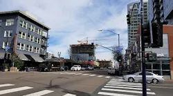 FIG. 1. San Diego is installing the Current CityIQ nodes on both cobrahead and decorative gaslamp-style poles with LED luminaires. The busy Market Street includes both types, and with two lanes of traffic in each direction and a turn lane, the sensor nodes with two-way cameras line both sides of the street. (Photo credits: All photos, Maury Wright.)