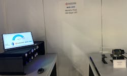 At the CES demo by Kyocera SLD Laser, 10 fibers fed the transmitter on the right with 7 different infrared wavelengths and 3 different blue wavelengths, each carrying data to the receiver on the left, where 10 different receivers were dedicated to one of the 10 wavelengths. The demo ran throughout the day at the company’s booth. The speed was close to 103 Gbps at the moment the photo was taken. (Photo credit: Image courtesy of KSLD.) At the CES demo by Kyocera SLD Laser, 10 fibers fed the transmitter on the right with 7 different infrared wavelengths and 3 different blue wavelengths, each carrying data to the receiver on the left, where 10 different receivers were dedicated to one of the 10 wavelengths. The demo ran throughout the day at the company’s booth. The speed was close to 103 Gbps at the moment the photo was taken. (Photo credit: Image courtesy of KSLD.)