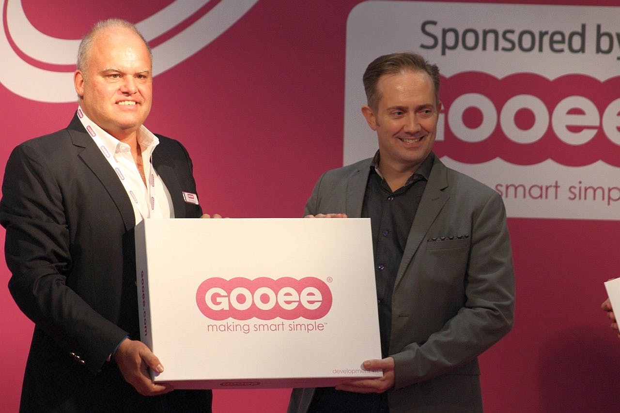 Gooee managing director Neil Salt (right) has long been a tireless advocate of the IoT. Here he is handing out Gooee development kits back in 2016 at London&rsquo;s LuxLive exhibition, before Gooee&rsquo;s focus changed. With him is Jan Kemeling, Gooee&rsquo;s former chief commercial officer, who left the company in January. (Photo credit: Image courtesy of Mark Halper.)