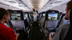The tray tables are up, but the Li-Fi wasn’t always in the right position as finalists competed in a gaming competition aboard an Air France Paris-to-Toulouse flight. (Photo credit: Image courtesy of Air France.)