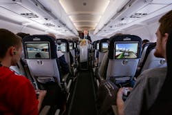 The tray tables are up, but the Li-Fi wasn’t always in the right position as finalists competed in a gaming competition aboard an Air France Paris-to-Toulouse flight. (Photo credit: Image courtesy of Air France.) The tray tables are up, but the Li-Fi wasn’t always in the right position as finalists competed in a gaming competition aboard an Air France Paris-to-Toulouse flight. (Photo credit: Image courtesy of Air France.)