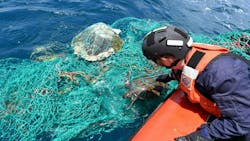 Sea turtles commonly ensnare themselves in fishing nets. In this photo, a U.S. Coast Guard officer frees one in the Atlantic Ocean off the coast of Africa. Sea turtles commonly ensnare themselves in fishing nets. In this photo, a U.S. Coast Guard officer frees one in the Atlantic Ocean off the coast of Africa.