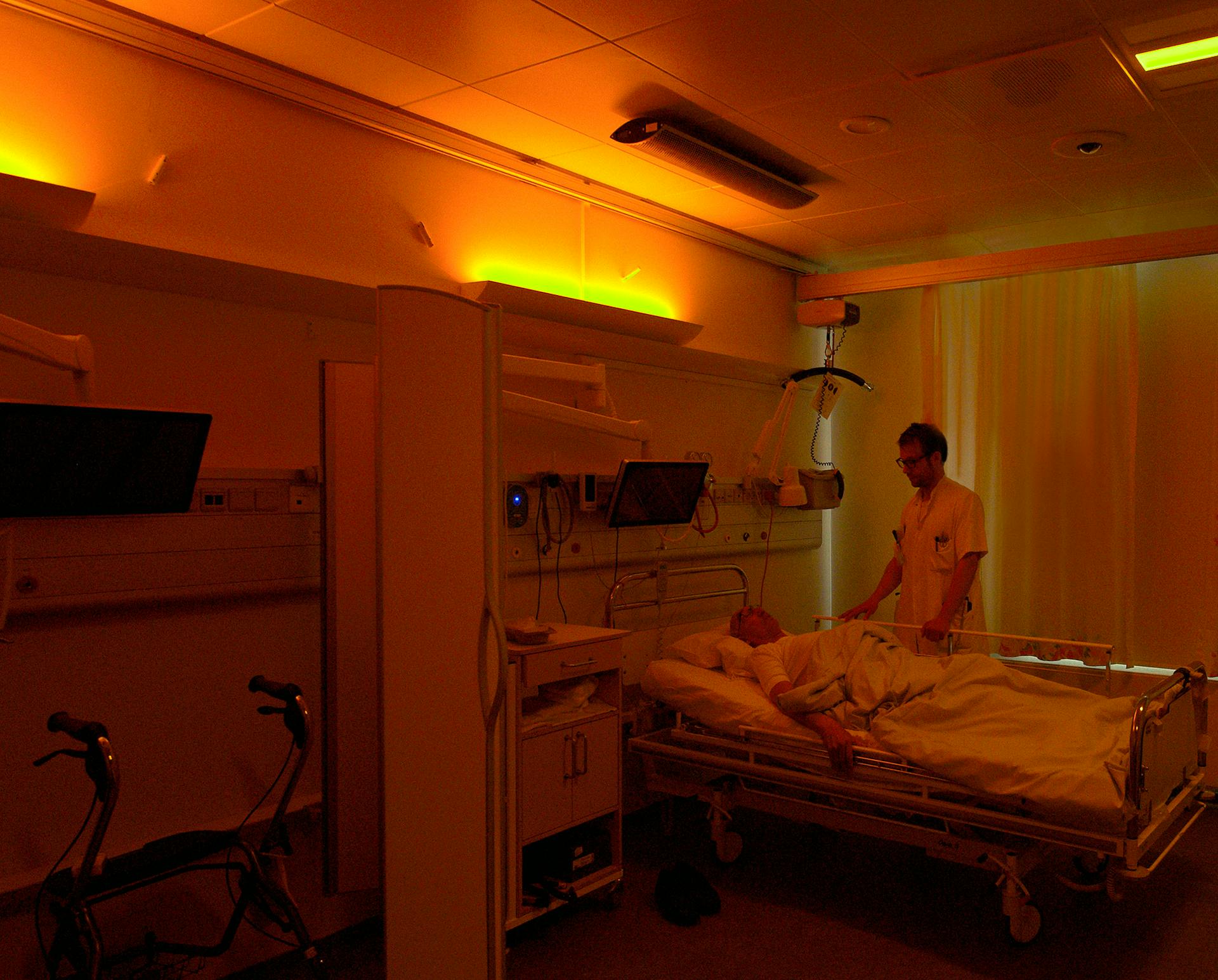 A stroke patient under soft warm nighttime lighting at Righospitalet, with neurologist Anders West of the University of Copenhagen. (Photo credit: Image courtesy of Chromaviso.)