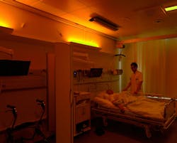 A stroke patient under soft warm nighttime lighting at Righospitalet, with neurologist Anders West of the University of Copenhagen. (Photo credit: Image courtesy of Chromaviso.) A stroke patient under soft warm nighttime lighting at Righospitalet, with neurologist Anders West of the University of Copenhagen. (Photo credit: Image courtesy of Chromaviso.)