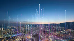 Aerial view of city at dusk with graphic overlay of tech connectivity concept.