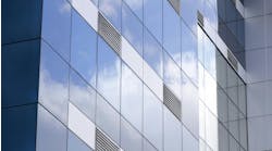 Exterior of modern glass building with ventilation grates. Exterior of modern glass building with ventilation grates.