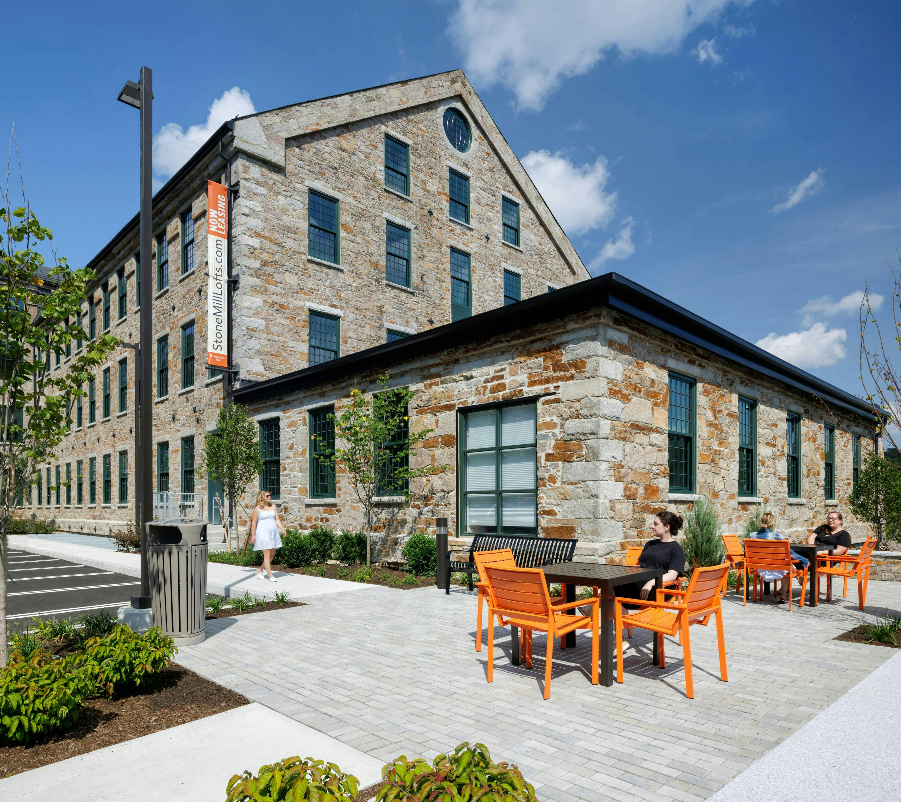 Outdoor courtyard with tables and seating at Stone Hill Lofts.
