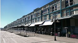 An adaptive reuse of a historic industrial wharf building at Finger Wharf, Woolloomooloo in Sydney, Australia. The heritage timber structure, featuring a green frame, white shutters, and louvers, has been transformed into the Ovolo Hotel, restaurants, and residential apartments, blending history with modern waterfront living. An adaptive reuse of a historic industrial wharf building at Finger Wharf, Woolloomooloo in Sydney, Australia. The heritage timber structure, featuring a green frame, white shutters, and louvers, has been transformed into the Ovolo Hotel, restaurants, and residential apartments, blending history with modern waterfront living.
