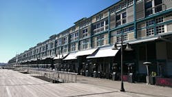 An adaptive reuse of a historic industrial wharf building at Finger Wharf, Woolloomooloo in Sydney, Australia. The heritage timber structure, featuring a green frame, white shutters, and louvers, has been transformed into the Ovolo Hotel, restaurants, and residential apartments, blending history with modern waterfront living. An adaptive reuse of a historic industrial wharf building at Finger Wharf, Woolloomooloo in Sydney, Australia. The heritage timber structure, featuring a green frame, white shutters, and louvers, has been transformed into the Ovolo Hotel, restaurants, and residential apartments, blending history with modern waterfront living.