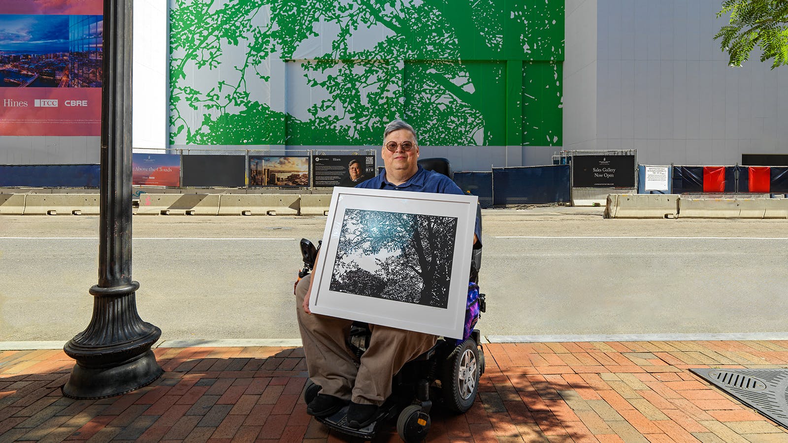 South Station Tower in Boston hosts a 6,500-square-foot reproduction of &ldquo;Emerald Tree&rdquo; by Allen Chamberland. The large-scale installation on construction scrim is seen by more than 75,000 people daily and is currently the largest mural in Boston. ArtLifting also offers creative art applications like glass film to provide privacy and placemaking, as well as an acoustic felt installation that contributes to noise reduction.