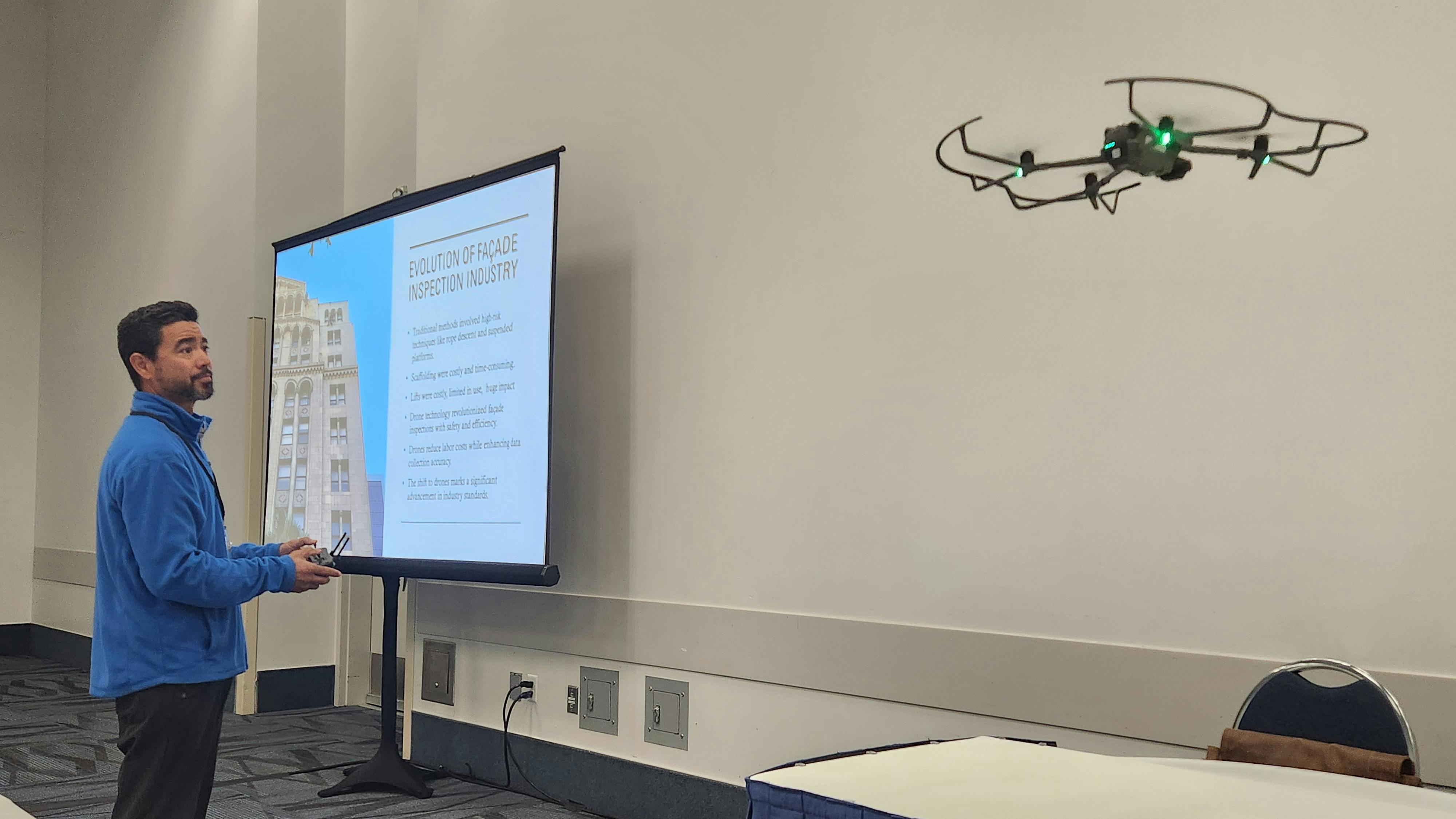 Ethan Pisz, chief drone operator for RayAccess, Inc., flies a drone at the 2025 Southern California Facilities Expo.