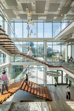 A monumental staircase, meant to encourage movement and conversation, was designed and created by Heirloom Companies, a South Carolina wood and iron artisan. It was designed in a way that minimizes obstruction of the outdoors via floor-to-ceiling windows. A monumental staircase, meant to encourage movement and conversation, was designed and created by Heirloom Companies, a South Carolina wood and iron artisan. It was designed in a way that minimizes obstruction of the outdoors via floor-to-ceiling windows.