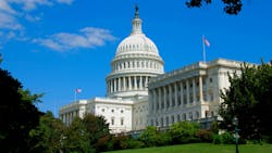 U.S Capitol building with lawn in foreground and clear, blue sky in background. U.S Capitol building with lawn in foreground and clear, blue sky in background.