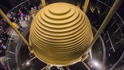 Image of massive, spherical seismic damper in building suspended by cables. Image of massive, spherical seismic damper in building suspended by cables.