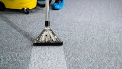 A janitor cleans a carpet. A janitor cleans a carpet.